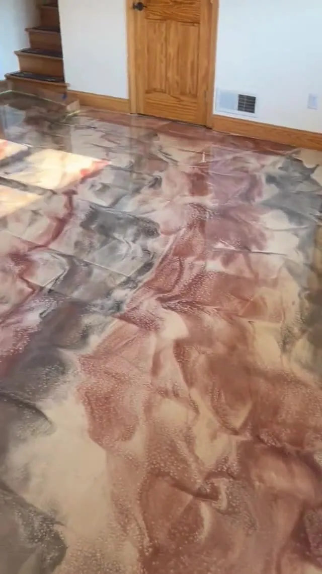 A copper metallic floor at the foot of a staircase