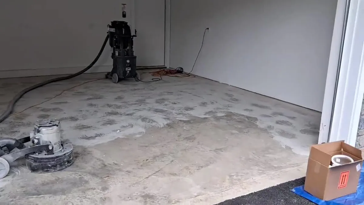 Grinders on a garage slab that has been ground back to bare concrete